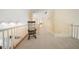 Hallway with carpet floors, railing, chair, and white walls at 125 Savannah Estates Dr, Atlanta, GA 30350