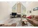 Spacious living room featuring a fireplace, soaring ceilings, and ample natural light at 125 Savannah Estates Dr, Atlanta, GA 30350