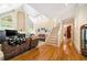 Open living room with high ceilings, hardwood floors, and staircase access at 125 Savannah Estates Dr, Atlanta, GA 30350