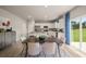 Modern kitchen and dining area with white cabinets, stainless steel appliances, and outdoor view at 237 Paisley Way, Locust Grove, GA 30248
