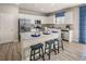 Modern kitchen with stainless steel appliances, granite countertops, and a breakfast bar with seating at 237 Paisley Way, Locust Grove, GA 30248