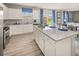 Well-lit kitchen with granite countertops, island, stainless steel appliances, and view to the backyard at 237 Paisley Way, Locust Grove, GA 30248