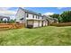 Spacious backyard with a well-maintained lawn, wooden fence, and covered hot tub at 247 Creek View Ln, Acworth, GA 30102