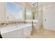 Luxurious bathroom with soaking tub, mosaic tile accents, and a glass-enclosed shower at 247 Creek View Ln, Acworth, GA 30102
