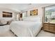Bright and airy primary bedroom with white bedding and neutral decor at 247 Creek View Ln, Acworth, GA 30102