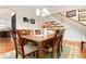 Inviting dining room with a wooden table, comfortable seating, and views of the staircase at 247 Creek View Ln, Acworth, GA 30102