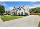 Spacious home with a long driveway and attached two-car garage in a lush green neighborhood at 247 Creek View Ln, Acworth, GA 30102