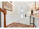 Bright foyer with hardwood floors, decorative wainscoting, and elegant console table at 247 Creek View Ln, Acworth, GA 30102