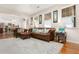 Cozy living room with classic leather furniture, neutral rug, and abundant natural light at 247 Creek View Ln, Acworth, GA 30102