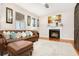 Inviting living room with a comfortable leather couch, fireplace, and large windows at 247 Creek View Ln, Acworth, GA 30102