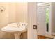 Bathroom featuring a classic pedestal sink and a door leading to the exterior at 2551 Village Creek Se Lndg, Atlanta, GA 30316