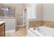 Bathroom with tub and separate shower; features tile floor and neutral paint at 2551 Village Creek Se Lndg, Atlanta, GA 30316