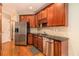 Well-equipped kitchen with stainless steel appliances and dark wood cabinets at 2551 Village Creek Se Lndg, Atlanta, GA 30316