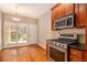 Kitchen with stainless steel appliances, granite countertops, and wood cabinetry at 2551 Village Creek Se Lndg, Atlanta, GA 30316