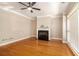 Bright living room featuring hardwood floors, a fireplace, ceiling fan, and large windows at 2551 Village Creek Se Lndg, Atlanta, GA 30316