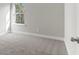 Bedroom has soft gray carpet and large windows that offer views of the trees outdoors at 3926 Lockaby Way, Lawrenceville, GA 30044