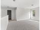 Bright bedroom features soft gray carpet and natural light from a window with backyard views at 3926 Lockaby Way, Lawrenceville, GA 30044