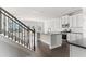 Contemporary kitchen featuring granite countertops, stainless steel appliances, and staircase access at 3926 Lockaby Way, Lawrenceville, GA 30044