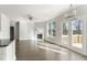 Open-concept living room featuring hardwood floors, modern lighting, and French door access to the outside at 3926 Lockaby Way, Lawrenceville, GA 30044