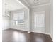 Bright living room featuring hardwood floors, wainscoting and a large window at 3926 Lockaby Way, Lawrenceville, GA 30044