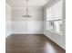 Bright living room featuring hardwood floors, wainscoting and a large window at 3926 Lockaby Way, Lawrenceville, GA 30044