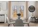 Cozy dining area with a round table, stylish chairs, and views of the outdoor deck at 48 Hampton Ter, Dallas, GA 30157