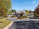 Exterior daytime shot of community center; circular drive, well-maintained landscaping, covered walkway to gazebo at 48 Hampton Ter, Dallas, GA 30157