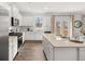 Modern kitchen featuring white cabinets, stainless steel appliances, granite countertops and eat-in dining area at 48 Hampton Ter, Dallas, GA 30157