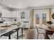 Modern kitchen with white cabinets, granite countertops, stainless steel appliances, and a cozy breakfast nook at 48 Hampton Ter, Dallas, GA 30157
