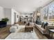 Open-concept living room featuring hardwood floors, a modern sofa, and an adjacent eat-in kitchen at 48 Hampton Ter, Dallas, GA 30157