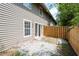 Backyard patio with privacy fence, white stone ground cover, and vinyl siding on home at 7750 Roswell Rd # 3D, Atlanta, GA 30350
