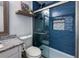 Bathroom features updated vanity with granite countertop, walk-in shower with blue subway tile and glass door at 7750 Roswell Rd # 3D, Atlanta, GA 30350