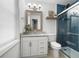 Bathroom features updated vanity with granite countertop, walk-in shower with blue subway tile and glass door at 7750 Roswell Rd # 3D, Atlanta, GA 30350