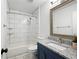 Updated bathroom with white subway tile surround tub and modern vanity with granite counters at 7750 Roswell Rd # 3D, Atlanta, GA 30350