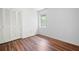 Bedroom features wood flooring, neutral walls, one window, and closet with louvered doors at 7750 Roswell Rd # 3D, Atlanta, GA 30350