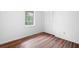 Bedroom features wood flooring, neutral walls, one window, and closet with louvered doors at 7750 Roswell Rd # 3D, Atlanta, GA 30350