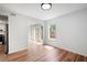 Dining room features hardwood floors, white walls, a window, and French doors to the patio at 7750 Roswell Rd # 3D, Atlanta, GA 30350