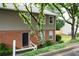 Townhouse exterior featuring brick accents, siding, and a welcoming entrance with a small, landscaped garden at 7750 Roswell Rd # 3D, Atlanta, GA 30350