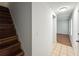 Hallway featuring hardwood floors and stairs leading to upper level, connecting different areas of the house at 7750 Roswell Rd # 3D, Atlanta, GA 30350