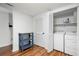 Well-lit laundry area with washer, dryer, storage, and hardwood floors, providing a functional space at 7750 Roswell Rd # 3D, Atlanta, GA 30350