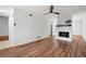 Living room with hardwood floors, white walls, a ceiling fan, and a fireplace at 7750 Roswell Rd # 3D, Atlanta, GA 30350