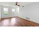 Spacious living room featuring hardwood floors, white walls, natural light, and a modern ceiling fan at 7750 Roswell Rd # 3D, Atlanta, GA 30350