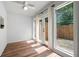 Sun-filled room with hardwood floors, large windows, and access to the backyard, ideal for relaxing at 7750 Roswell Rd # 3D, Atlanta, GA 30350