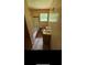 A compact bathroom featuring tiled walls, a window, a toilet, a sink, and a bathtub with an open shower head at 1024 Topaz Lane, Villa Rica, GA 30180