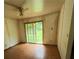 A compact bedroom exhibiting bare walls, vinyl flooring, and a sliding door leading to the outdoors at 1024 Topaz Lane, Villa Rica, GA 30180