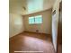 Bedroom featuring worn floors, bare walls, and natural light from the window at 1024 Topaz Lane, Villa Rica, GA 30180
