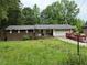 Exterior view of home, showing the front yard, garage, and a dumpster at 1024 Topaz Lane, Villa Rica, GA 30180