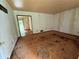 Unfurnished living room featuring bare walls and damaged flooring at 1024 Topaz Lane, Villa Rica, GA 30180