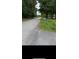 Street view showcasing a mailbox and a glimpse of the neighborhood, blending nature with accessibility at 1024 Topaz Lane, Villa Rica, GA 30180