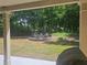Relaxing backyard with a stone firepit, surrounded by mature trees and landscaping at 124 Archstone Sq, Mcdonough, GA 30253